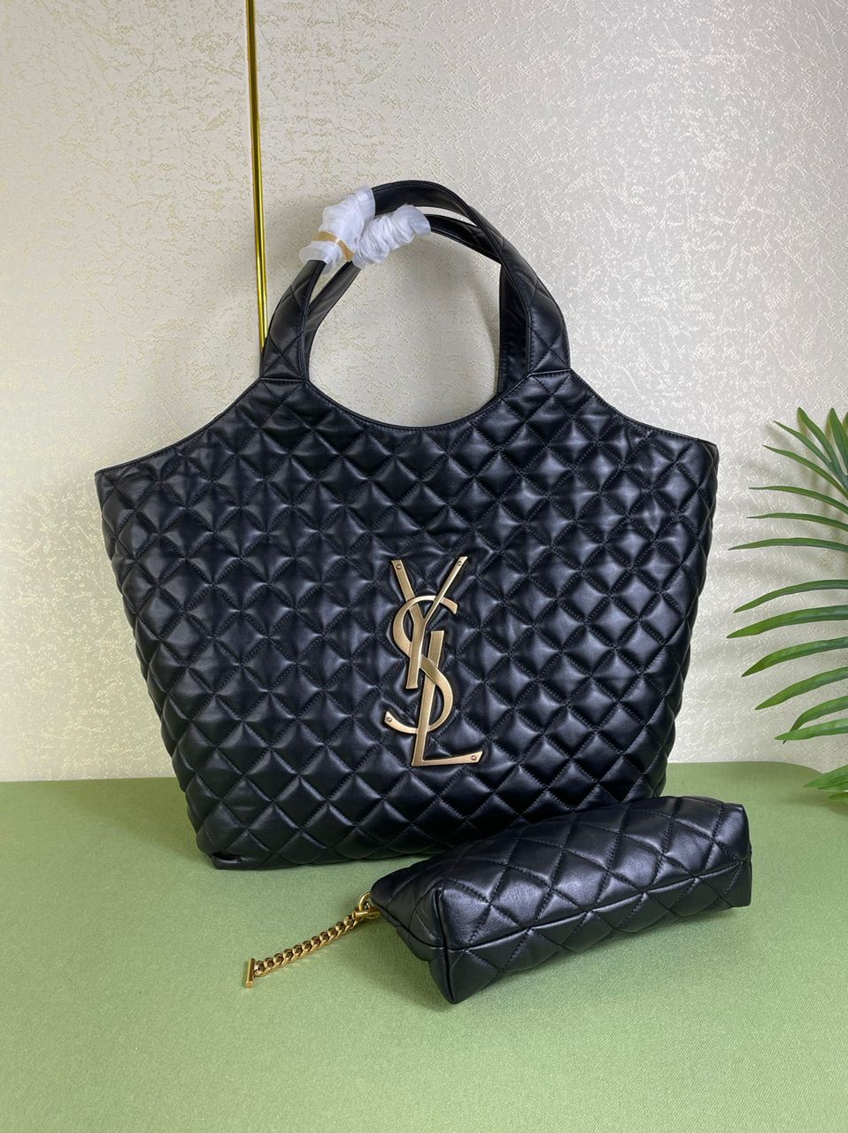 Black quilted Saint Laurent Icare bag with its matching pouch